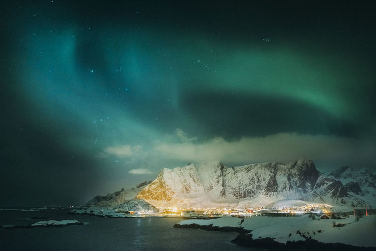 Scenic view of sea against sky at night during winter