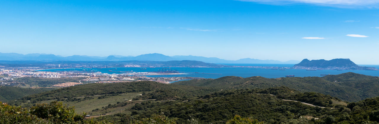 Scenic view of mountains against blue sky