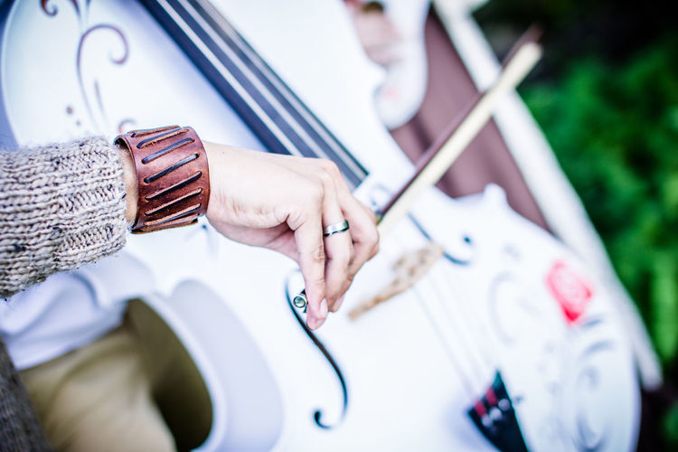 Cropped image of person playing cello