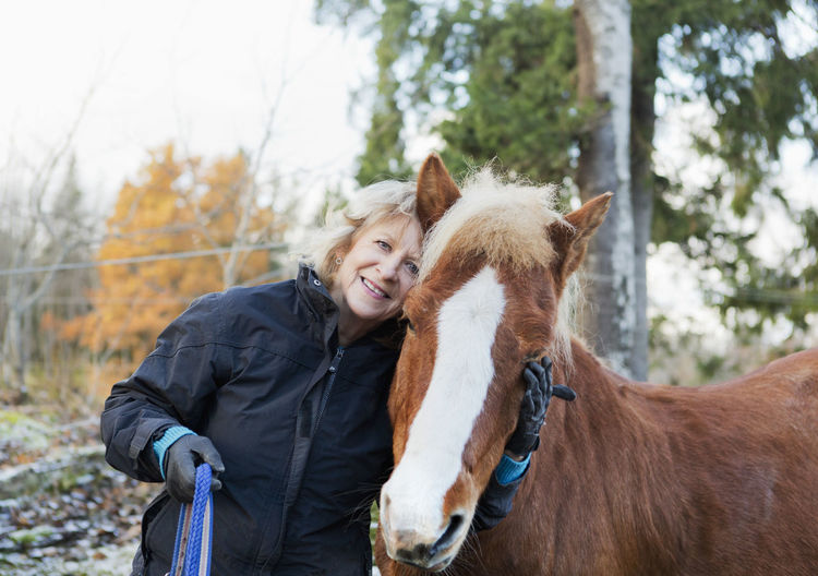 Senior woman with icelandic horse