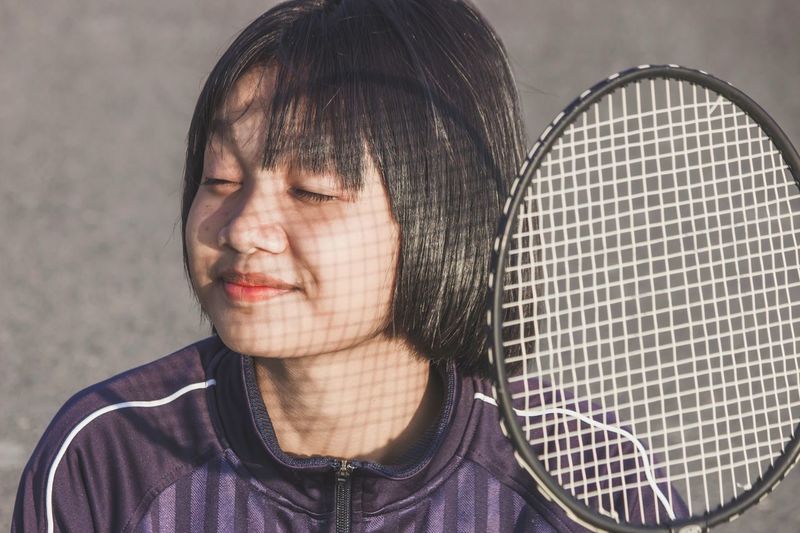 New normal lifestyle, free from disease. portrait of young woman with badminton racket.