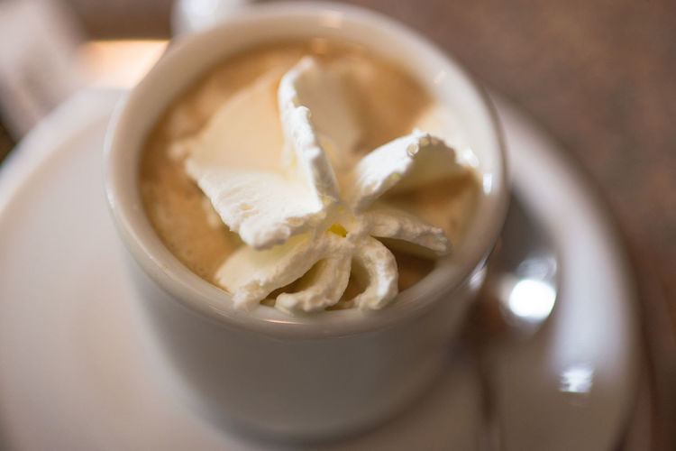 Close-up of whipped cream in coffee on table