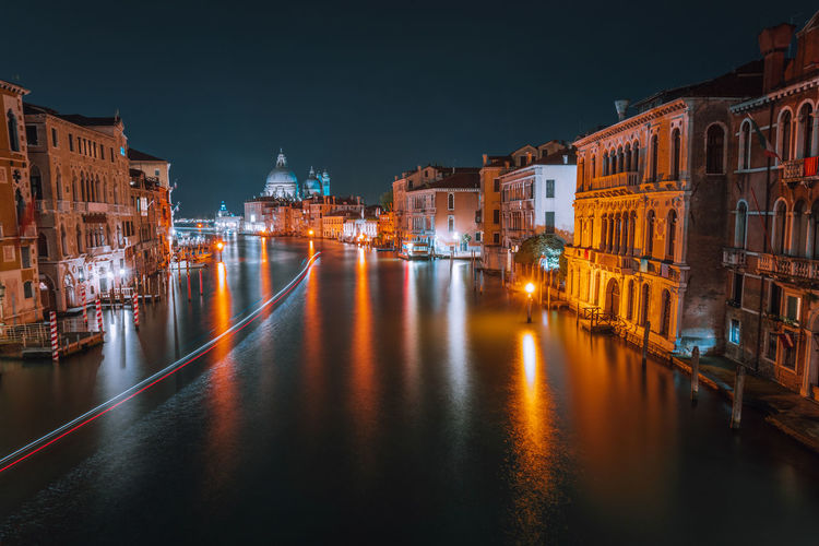 Grand canal amidst illuminated buildings in city at night