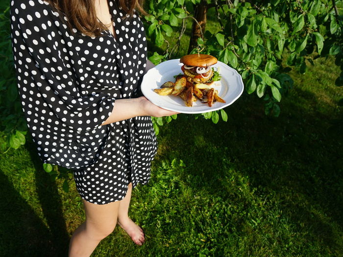 High angle view of woman holding food in plate