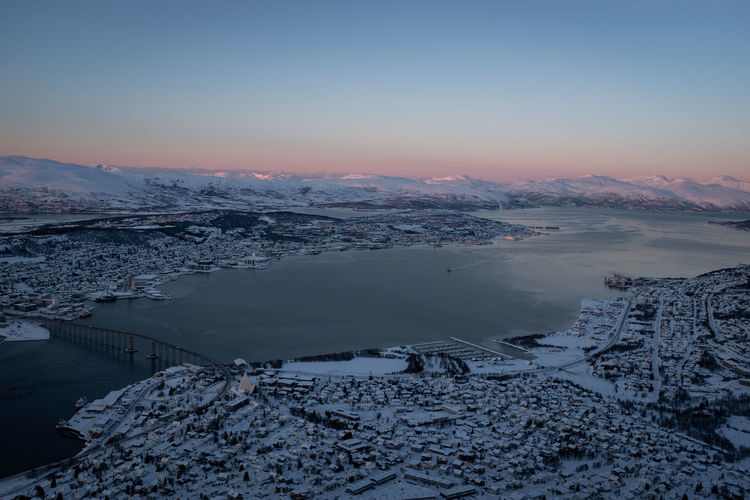 Tromsø norway cityscape in winter covered with snow. view of tromsøysundet strait. aerial shot.