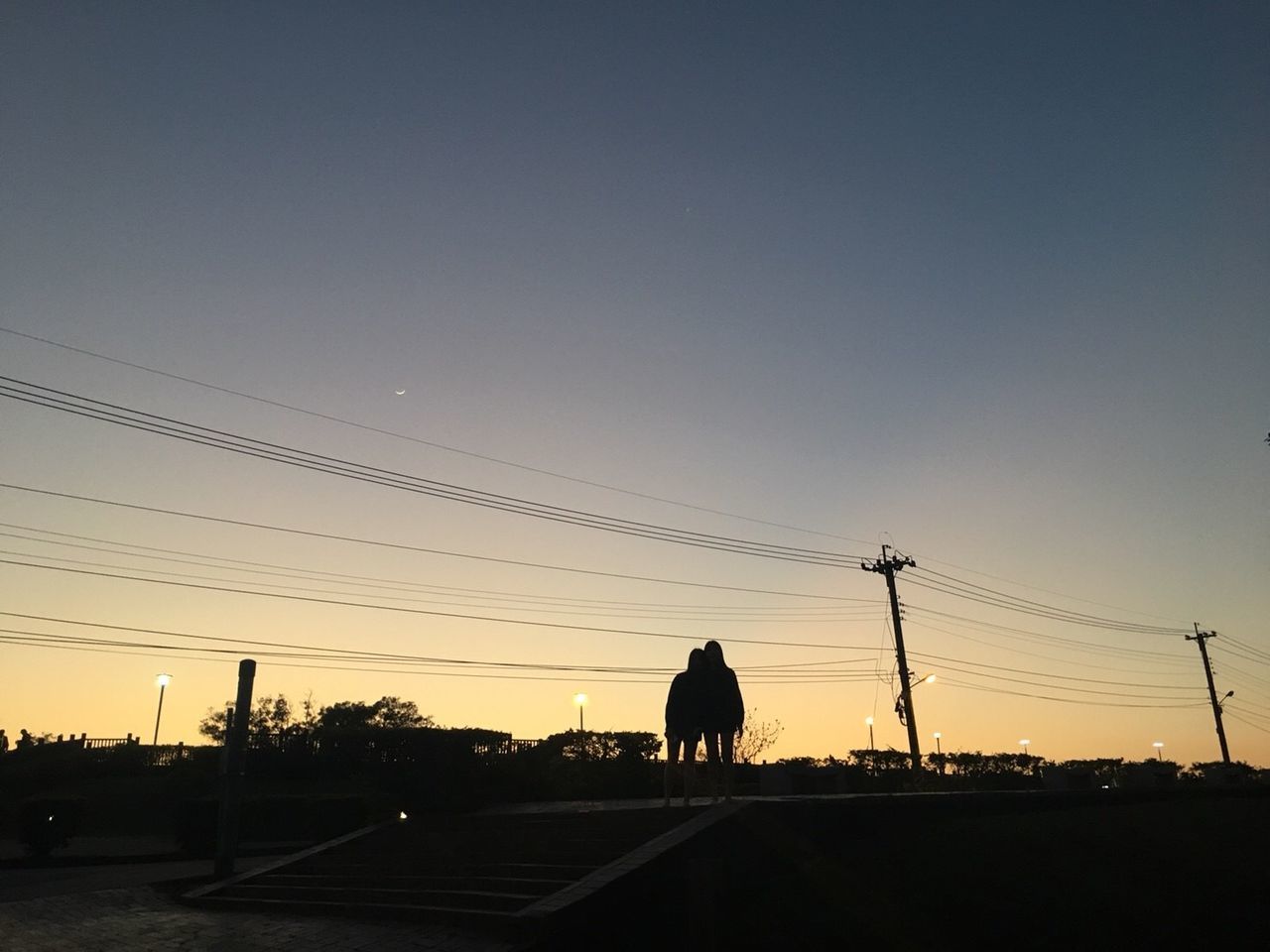 SILHOUETTE MAN ON ROAD AGAINST CLEAR SKY DURING SUNSET