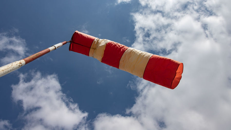 Low angle view of flags against sky