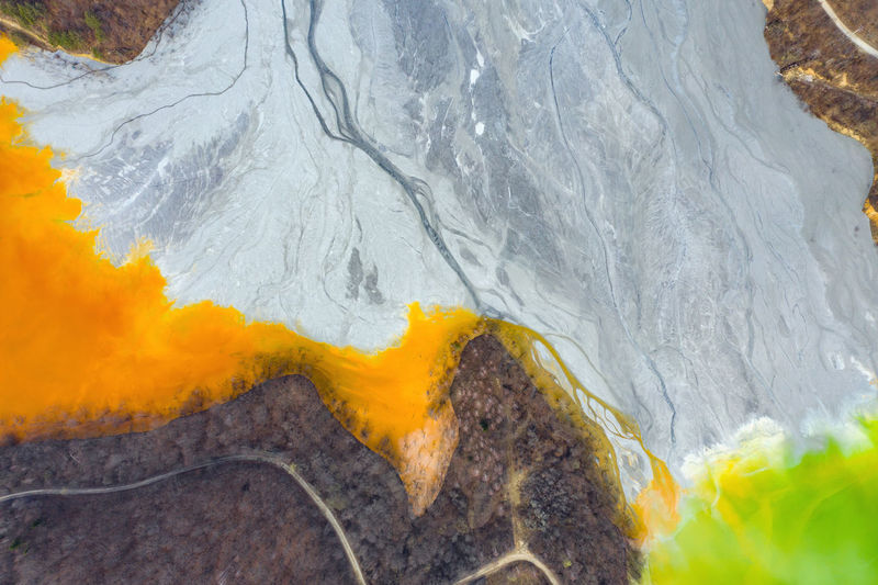 Lake polluted with yellow waste water, aerial view of mining decanting pond  from copper mine