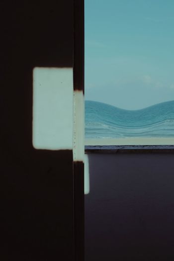 Close-up of sea seen through window
