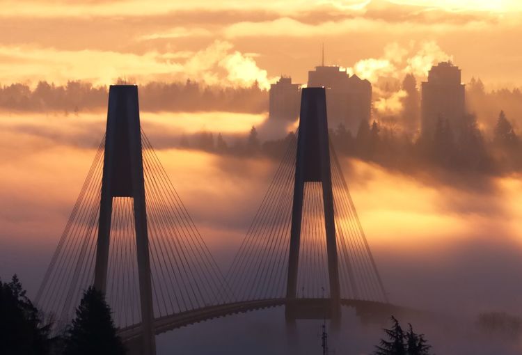 Low angle view of cable-stayed bridge against sky during sunset