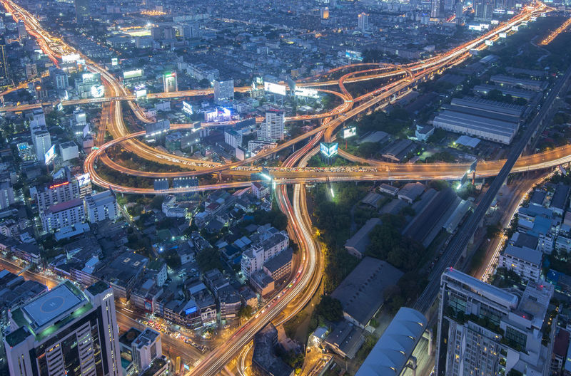 High angle view of illuminated city street and buildings at night