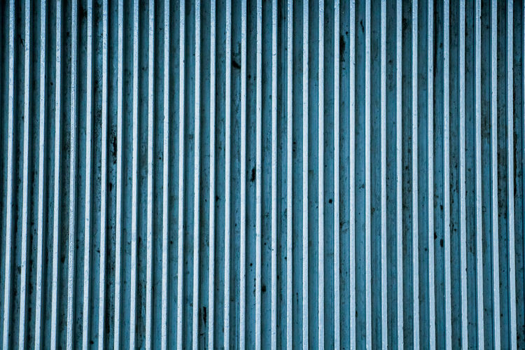 Striped blue metal plate texture close up