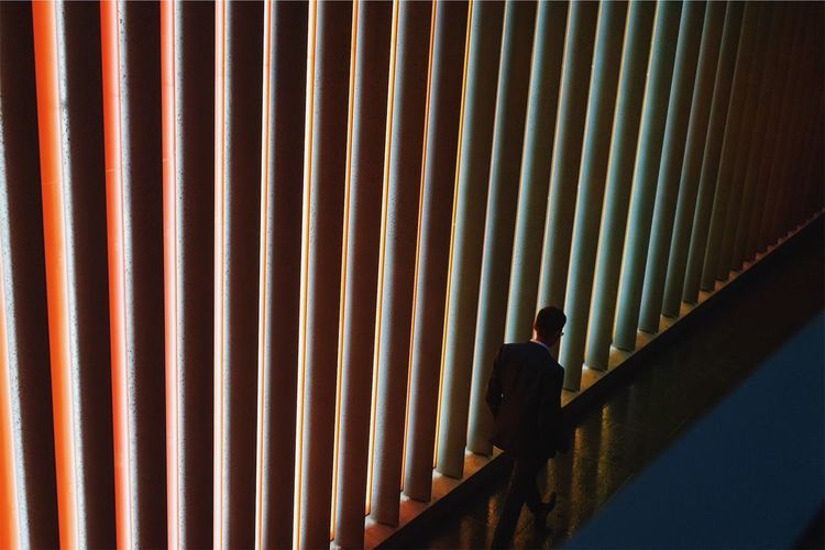 High angle view of businessman walking in corridor