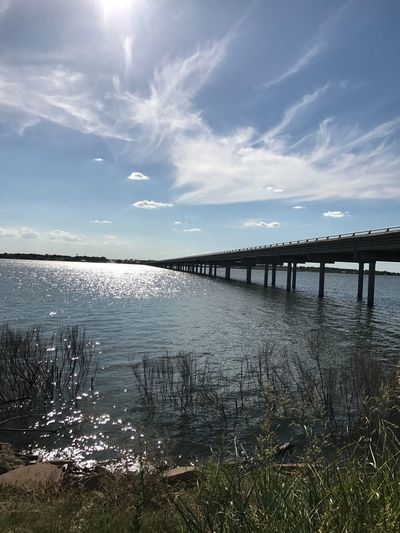 Bridge over lake against sky