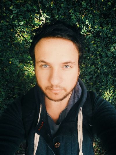 Portrait of man taking selfie against plants
