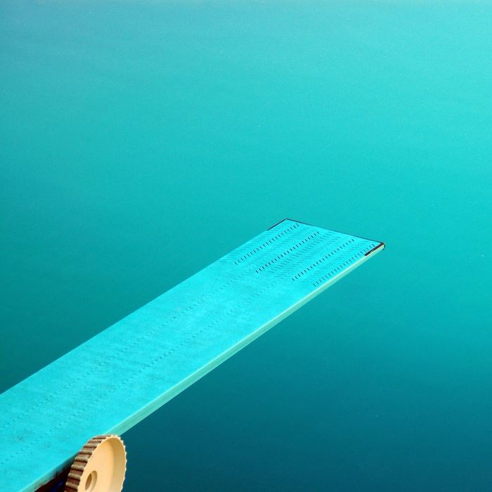 Diving board against swimming pool