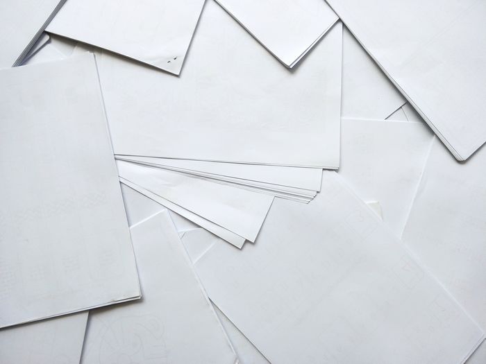 High angle view of white paper on wall
