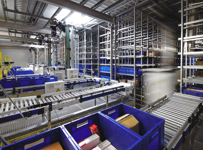 Automated warehouse. boxes with spare parts moving on conveyer