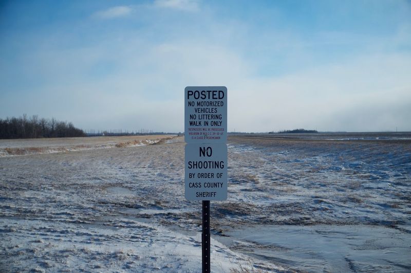 Warning sign on snow covered landscape