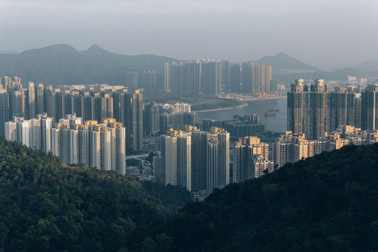 Aerial view of buildings in city against sky