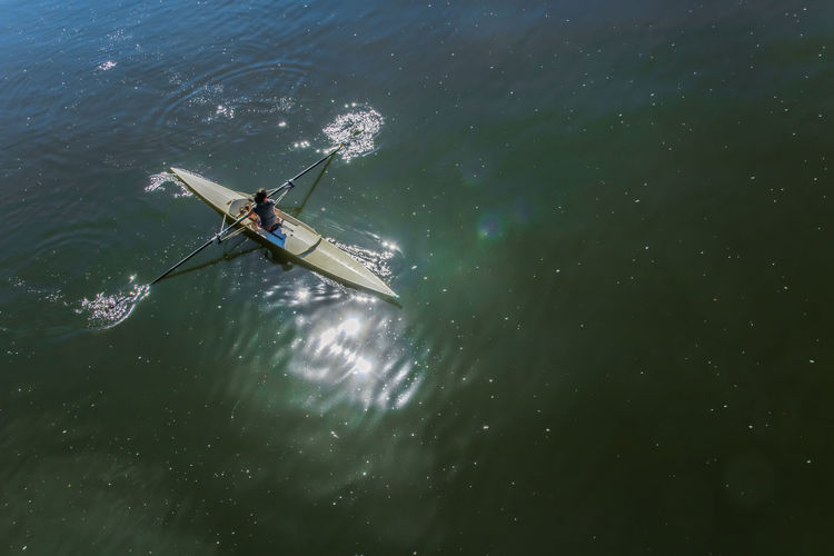 High angle view of woman sculling in river