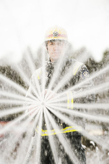 Fire fighter holding fire hose