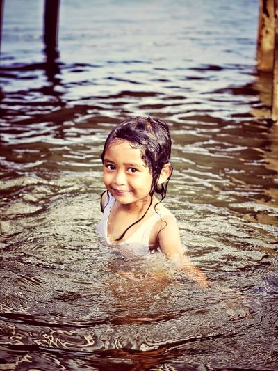 Portrait of smiling girl in water