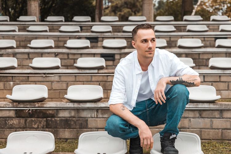 Young man sitting on bench