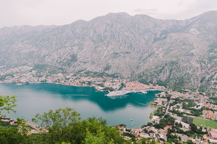 High angle view of lake and mountains against sky