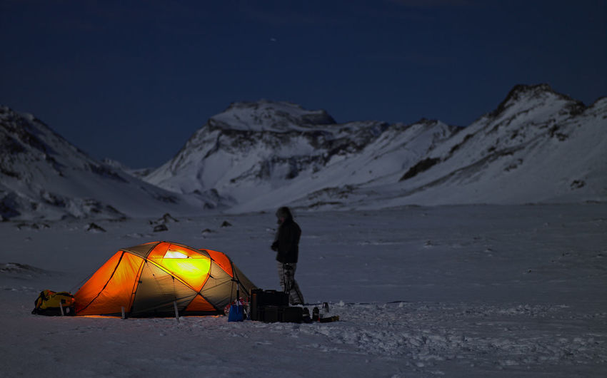 Illuminated tent at camp in the icelandic winter landscape