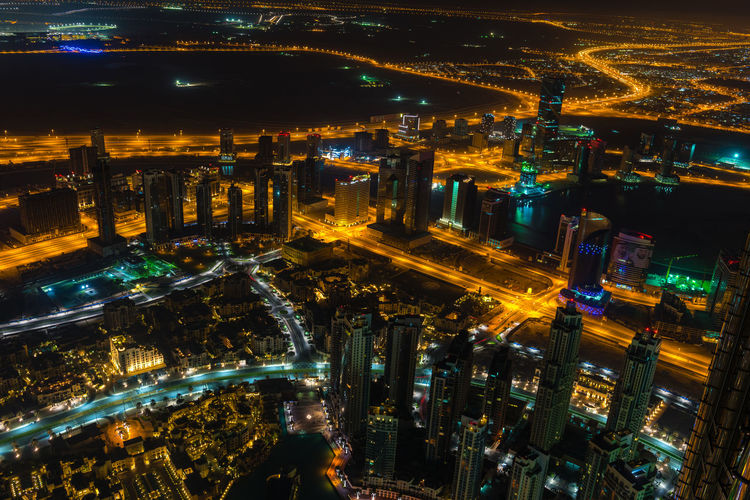 High angle view of city lit up at night