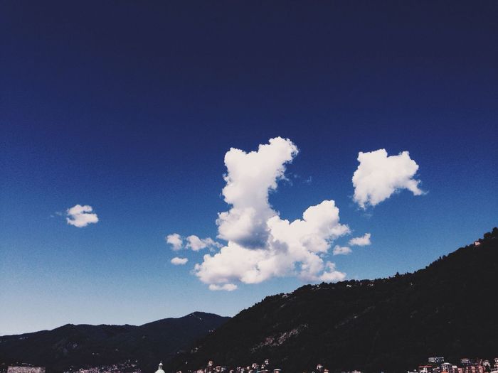 Scenic view of mountains against blue sky