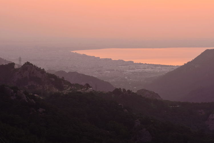 High angle view of mountains and lake against sky during sunset