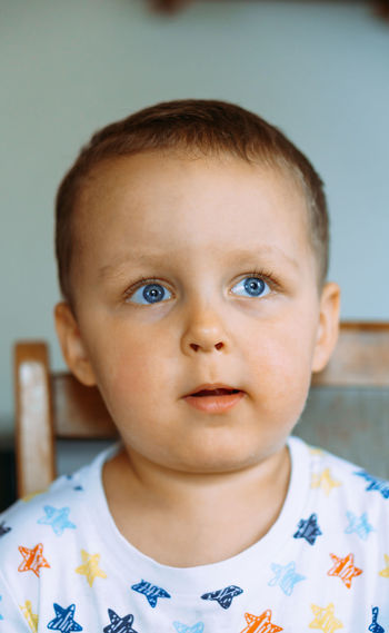 Close-up portrait of cute boy at home