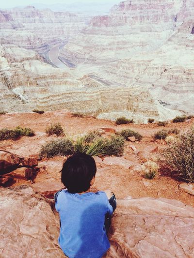 High angle view of man looking at rock formations