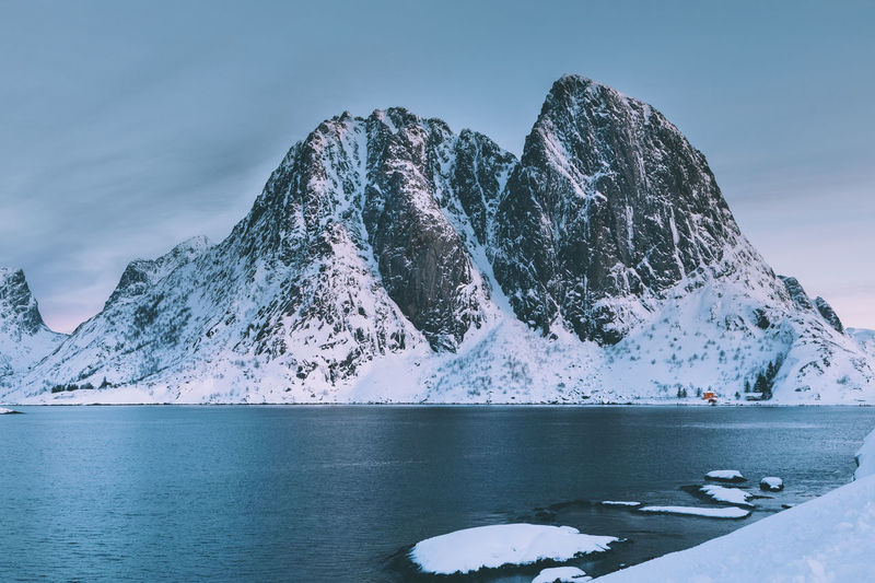 Frozen lake against mountain during winter
