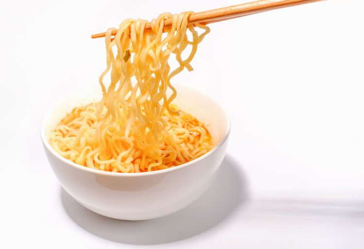 Close-up of pasta in bowl on white background
