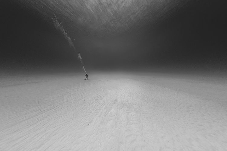 Woman standing on ocean floor