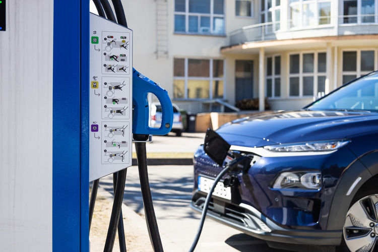Ev charging station with the power cable supply plugged in an electric car