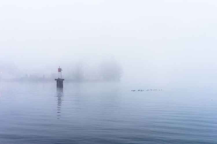 Scenic view of lake during foggy weather