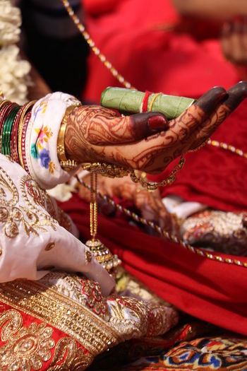 Cropped hand of bride with henna tattoo