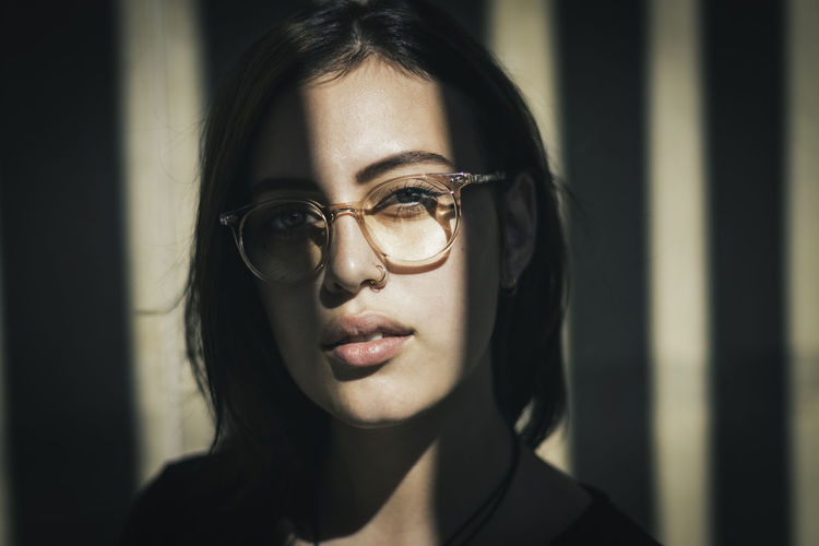 Close-up portrait of young woman wearing eyeglasses