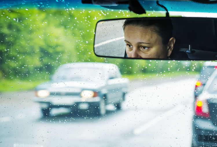 Reflection of woman in car