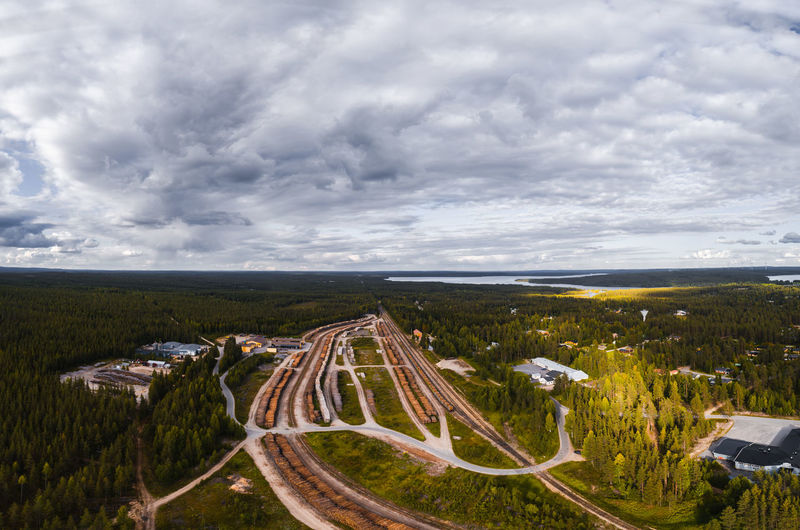 Aerial view of road amidst forest against sky