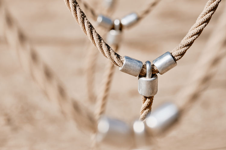 Close-up of rope tied to metal chain
