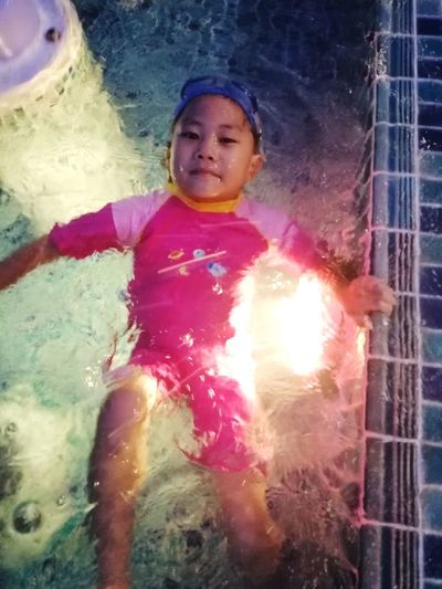 Portrait of cute girl in swimming pool