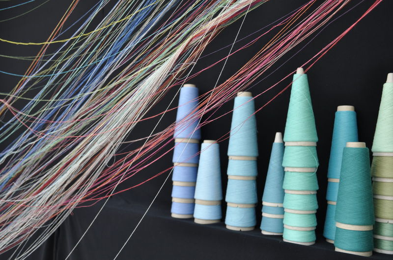 Close-up of multi colored spools and threads
