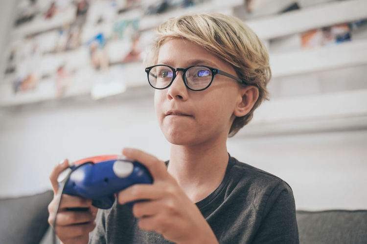 Boy playing video game at home