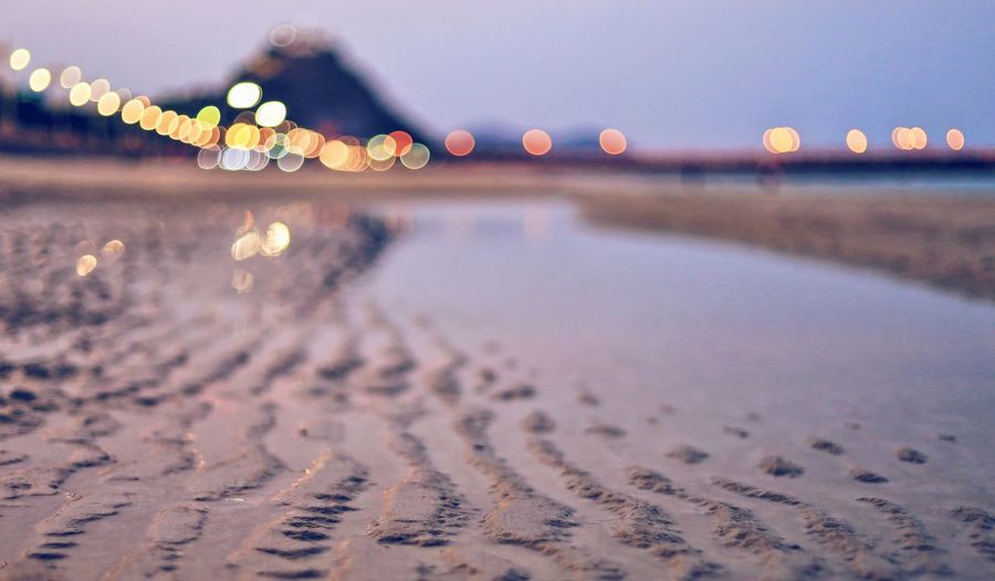 Surface level of water on beach against sky at night