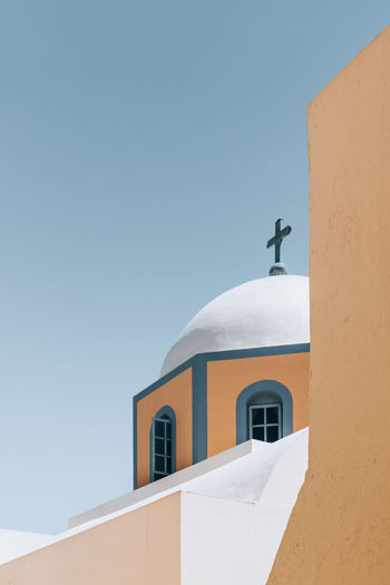 Low angle view of church against clear blue sky in santorini , greece
